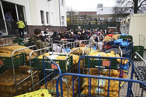 People gather in the courtyard at the Chabad Jewish Education Center to get food for Passover, in Berlin, Germany, Thursday, April 7, 2022. (Photo | AP)