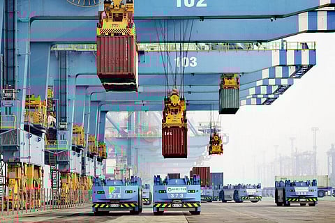 Driverless vehicles move shipping containers at a port in Qingdao in eastern China's Shandong Province, on Jan. 6, 2022.(Photo |AP)