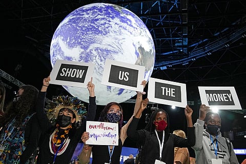 Activists engage in a 'Show US The Money' protest at the COP26 U.N. Climate Summit in Glasgow (File Photo | AP)