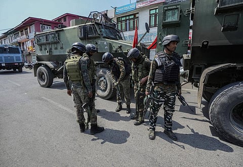An Indian paramilitary soldier checks his rifle as they arrive near site of a gun-battle between government forces and suspected rebels in Srinagar. (Photo | AP)