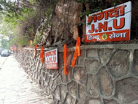 Hindu sena puts up saffron flag and posters outside the JNU Campus in New Delhi in Friday. (Photo | EPS)