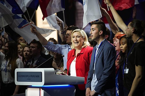 French far-right leader Marine Le Pen, center, sings the French anthem at the end of a meeting in Avignon, south of France, Thursday, April 14, 2022. (Photo | AP)