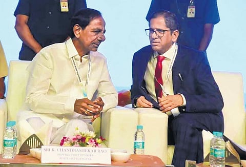 Chief Minister K Chandrasekhar Rao speaks to CJI Justice N V Ramana during the inauguration of the Telangana State Judicial Officers Conference 2022 in Hyderabad on Friday