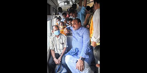 TDP president Atchannaidu speaks to a passenger in a bus on increased fares in Vizag on Friday | G Satyanarayana