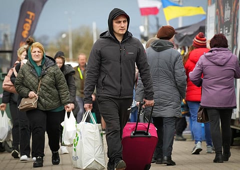People return back to Ukraine at the border crossing in Medyka, southeastern Poland, Saturday, April 9, 2022. (File Photo | AP)