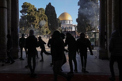 Palestinians clash with Israeli security forces at the Al Aqsa Mosque compound in Jerusalem's Old City Friday, April 15, 2022. (Photo | AP)
