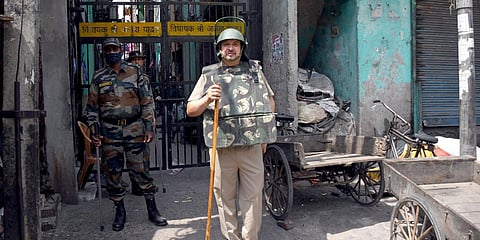 Paramilitary and police personnel stand guard at the site where violence broke out between two communities during Hanuman Jayanti, at Jahangirpuri, in New Delhi. (Photo| ANI)