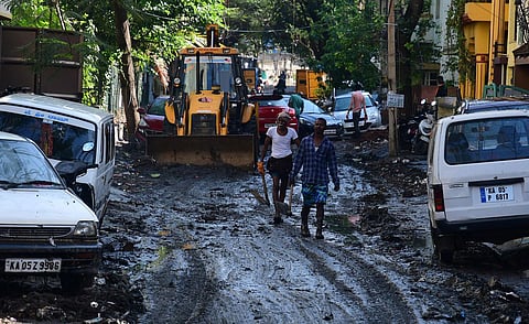 Residents having difficult time after heavy downpour on Thursday late evening near kamakya theatre in Banashankari. BBMP workers were seen clearing water. (Photo | Shriram BN, EPS)