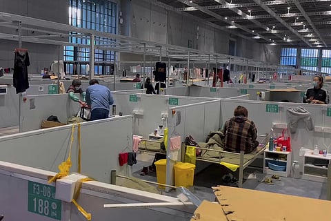 Residents take a rest at the quarantine facility set up for people who tested positive but have few or no symptoms on April 15, 2022, in Shanghai. (Photo | AP)