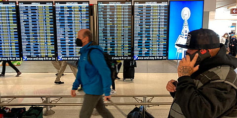 Travelers wearing facemasks walk through Seattle-Tacoma International Airport in Seattle. (Photo| AP)