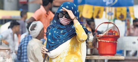 A women covers her head with a dupatta as she steps out in sizzling heat. (Photo | Parveen Negi)
