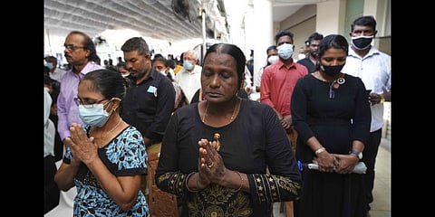 Survivors of the 2019 Sri Lanka Easter Sunday Attack pray during a holy mass at St. Anthony's church, one of the attack sites, during the third year remembrance.April 21, 2022.(Photo | AP)