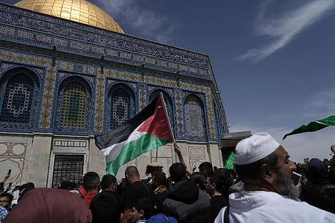 A worshipper waves the Palestinian flag after Friday prayers during the Muslim holy month of Ramadan. (Photo | AP)