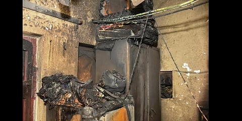 The house which was gutted after the battery of Boom Corbett 14 electric scooter (inset) exploded at Gulabi Thota in Vijayawada on Saturday | Prasant Madugula
