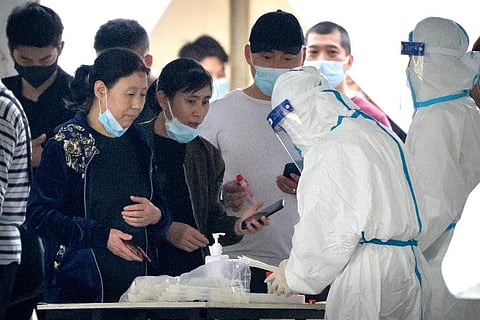 People register for Covid-19 tests at a coronavirus testing facility in Beijing. ( Photo | AP)
