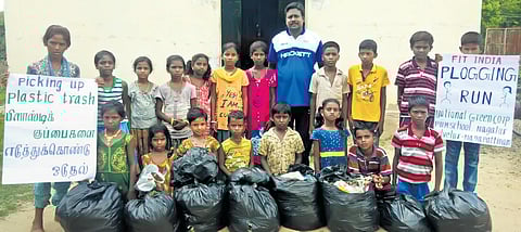 Children stand with plastic they collected on a plogging run| Express