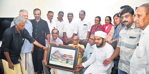 Representatives of Khasi Foundation honour the family head of the current descendants of Zamorins in Kozhikode on Sunday