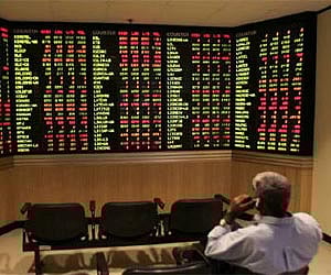 An investor monitors share market prices . ( Photo | Reuters)