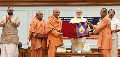 Prime Minister Narendraw Modi unveiling the logo of the 90th anniversary of Sivagiri pilgrimage at his residence in New Delhi on Tuesday, April 26, 2022.
