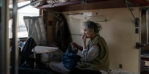 An elderly woman sits on a train at a train station in Pokrovsk, Ukraine, before departing to flee from the war in Severodonetsk and nearby towns. (Photo | AP)