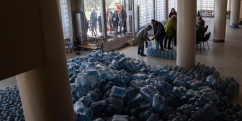 Local residents receive drinking water at a distribution centre in Toretsk, eastern Ukraine. (Photo | AP)