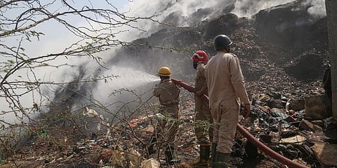 Firefighters try to douse a fire that broke out at Bhalswa landfill site, in New Delhi. (Photo | PTI)