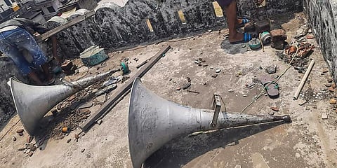 Workers remove loudspeakers from a religious building, in Gorakhpur. (Photo | PTI)