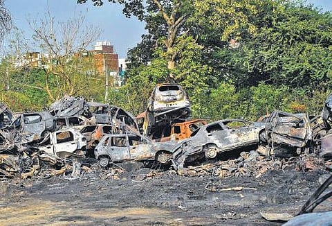 Remains of vehicles after a fire broke out at Swami Nagar district park | pti