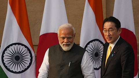 Indian Prime Minister Narendra Modi walks with his Japanese counterpart Fumio Kishida.
