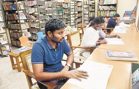 People engrossed in reading at government library at Villivakkam | R Satish Babu