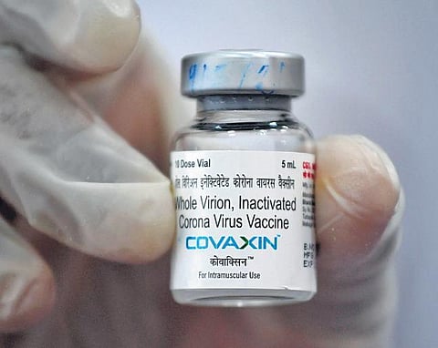 A vial of the Covaxin vaccine is being displayed by a medical worker. (File photo | AFP)
