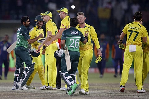 Pakistan's Babar Azam, left, and Imam-ul-Haq, center, shakes hand with Nathan Ellis and Ben McDermott after winning the third one day international cricket match against Australia. (Photo | AP)