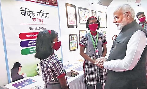 Prime Minister Narendra Modi interacting with Nanditha and Niveditha at their exhibition stall at the Pariksha Pe Charcha programme held at Talkatora stadium in New Delhi on Friday