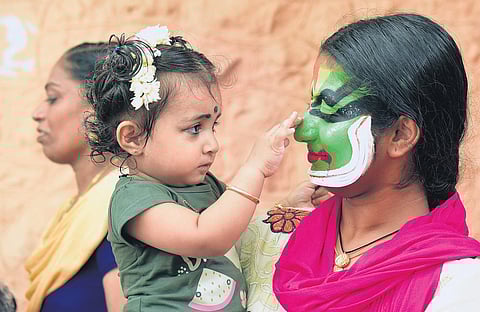 A kathakali participant spends time with her niece