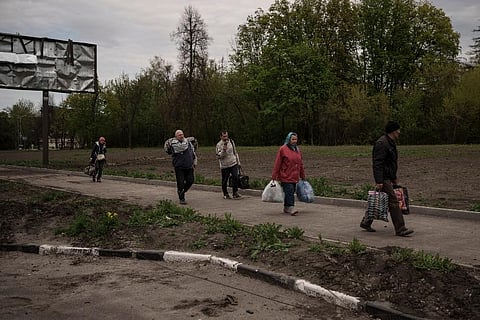 People fleeing the village of Ruska Lozova arrive at a screening point in Kharkiv, Ukraine. ( Photo |AP)