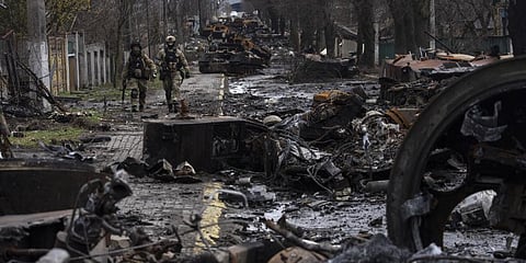 Soldiers walk amid destroyed Russian tanks in Bucha, on the outskirts of Kyiv, Ukraine, Sunday, April 3, 2022. (Photo |AP)
