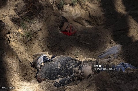 Bodies are seen in a mass grave in Motyzhyn village, Bucha district of Kyiv oblast, west of the Ukrainian capital Kyiv on April 4, 2022. (AFP)