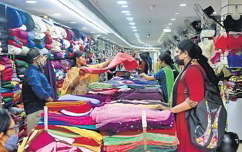 Customers selecting sarees from a textile shop at Pazhavangadi in Thiruvananthapuram | B P Deepu