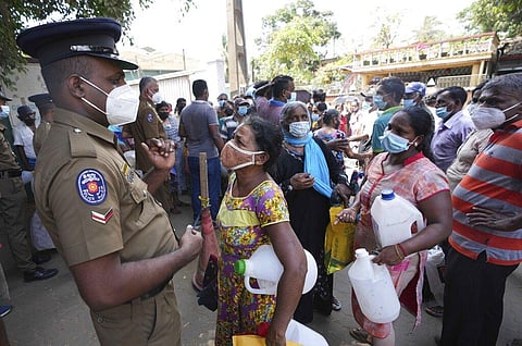 Sri Lankans wait at a fuel station after spending hours to unsuccessfully buy kerosene oil in Colombo, Sri Lanka, Thursday, April 7, 2022. (Photo | AP)