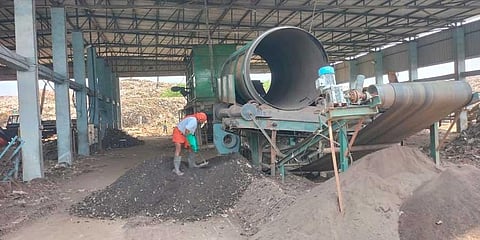 A worker collecting the manure separated through bio-mining process at the compost yard in Chekkadi | Express