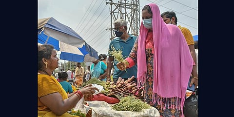 People purchase neem flowers to celebrate Telugu New Year Ugadi in a traditional manner in Vijayawada on Friday. (Photo | EPS)