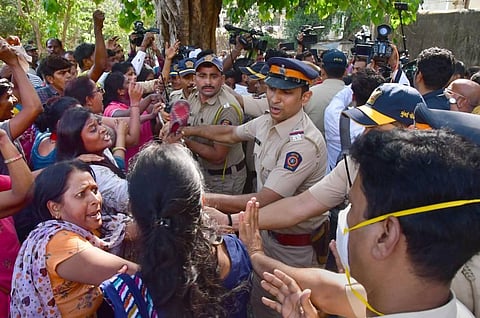 Police in a scuffle with employees of MSRTC as they protest demanding the merger of the MSRTC with the state government, outside the residence of NCP Chief Sharad Pawar's residence. (Photo | PTI)