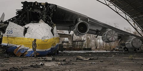 A Ukrainian serviceman walks by the Antonov An-225 Mriya aircraft destroyed during the war.(Photo | AP)