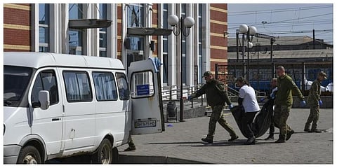 Ukrainian servicemen carry a body after Russian shelling at the railway station in Kramatorsk, Ukraine, Friday, April 8, 2022. (Photo | AP)