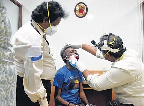 File photo of a doctor examining a patient with black fungus infection
