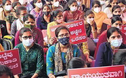 Candidates who wrote the PSI recruitment exam in October last year protest against the state government’s decision to conduct re-exam, in Bengaluru on Saturday | shriram bn