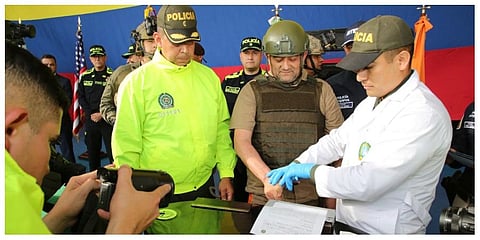 Police fingerprint Dairo Antonio Usuga, also known as 'Otoniel,' leader of the violent Clan del Golfo cartel prior to his extradition to the US, at a military airport in Bogota, Colombia. (Photo | AP)