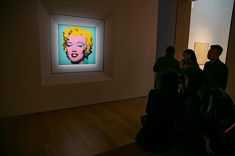 The 1964 silk-screen image, 'Shot Sage Blue Marilyn,' by Andy Warhol is visible in Christie's showroom in New York City. (Photo | AP)