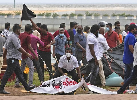 Sri Lanka's pro government supporters vandalise the camps of anti government protestors outside the president's office in Colombo. (Photo | AP)