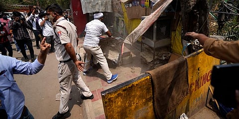 Delhi Municipal Corporation workers dismantle an illegal roadside shop during an anti-encroachment drive in New Delhi. (Photo | AP)